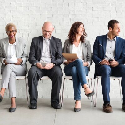 Diverse job candidates wait for interview.