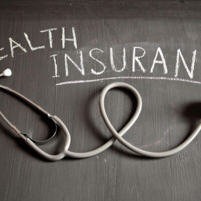 Stethoscope and chalkboard: Health insurance.