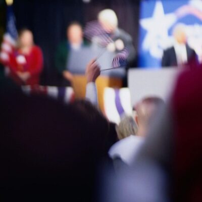 A blurry image of a crowd at a political event.
