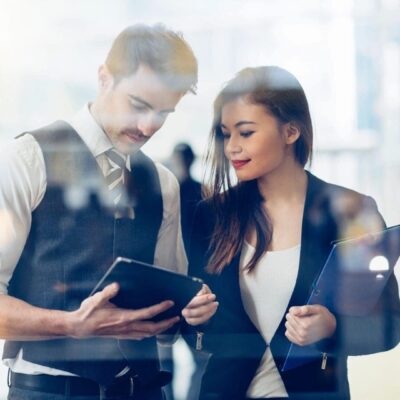 Two business people looking at a tablet.