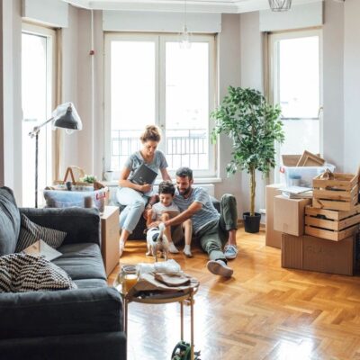 Family unpacking boxes in new home.