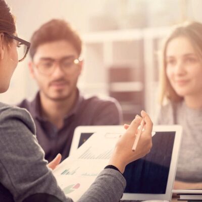 Financial advisor presenting data to couple.