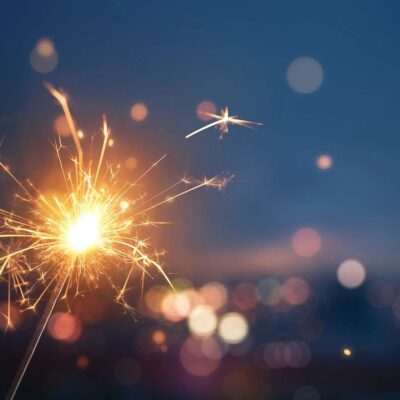 A sparkler with bokeh lights in the background.