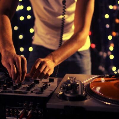 A dj is mixing music on a turntable.