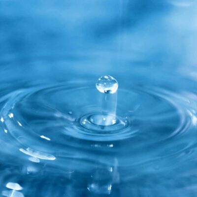 A drop of water on a blue background.