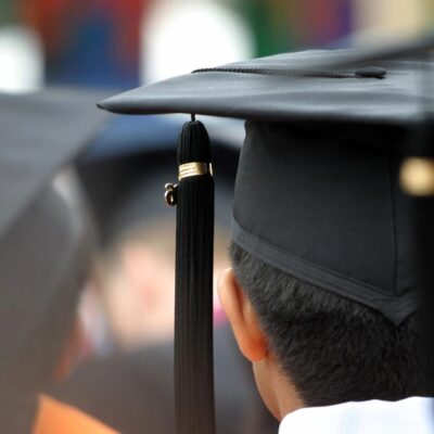 A group of graduates wearing graduation hats.