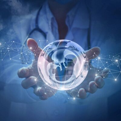 A doctor is holding a glass ball with a stethoscope in it.