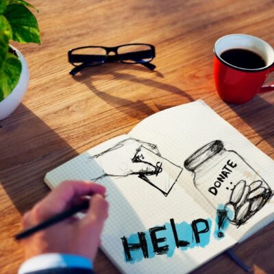 Notebook drawing with "Help" and donation jar.