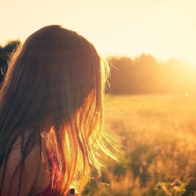 Woman's hair backlit by golden sunset.