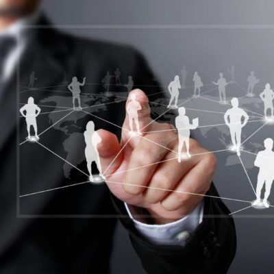 A businessman is pointing at a network of people.
