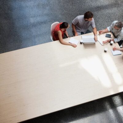A group of people sitting around a conference table.