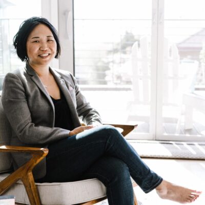 A woman sitting in a chair in a living room.