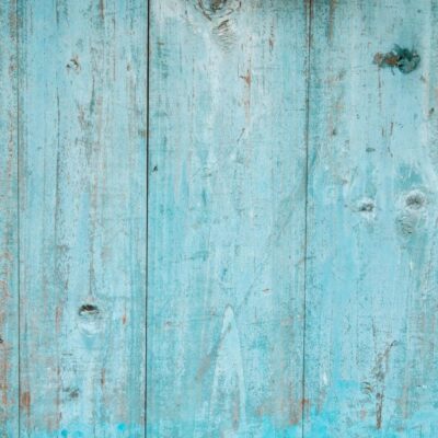 A close up of a blue painted wooden wall.