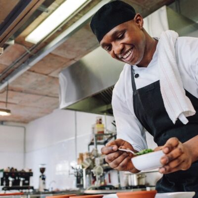A chef is preparing food in the kitchen.