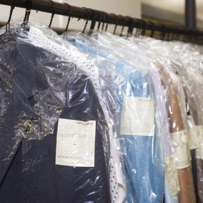 A rack of suits hanging in the closet
