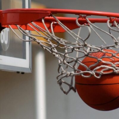 Basketball swishing through net.