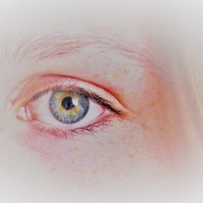 Close-up of a person's green eye.