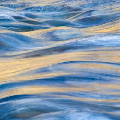 A close up of a river with blue and yellow water.