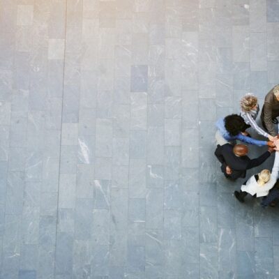 A group of business people standing together in a circle.