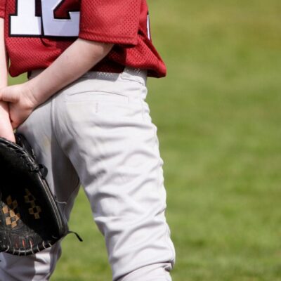 A boy wearing a baseball mitt.
