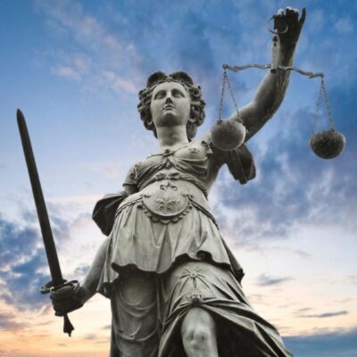 A statue of lady justice holding a sword and scales.