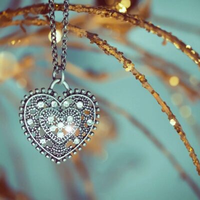 Intricate heart-shaped pendant hanging on a delicate chain.
