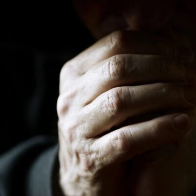 A person with their hands clasped together