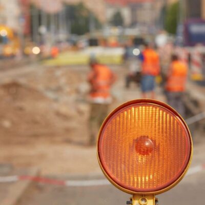 Here's an alt tag for the image: Orange construction warning light.