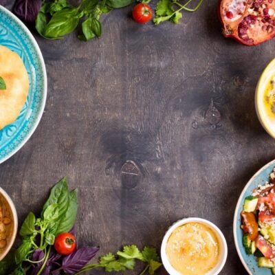 A variety of food on a dark wooden table.