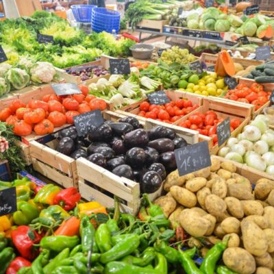 A variety of fruits and vegetables are on display at a market.