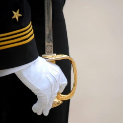 A close up of the hands and gloves on a uniform