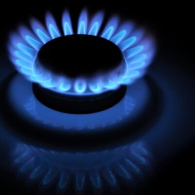 A blue gas flame on a black background.
