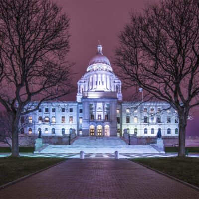The state capitol building is lit up at night.