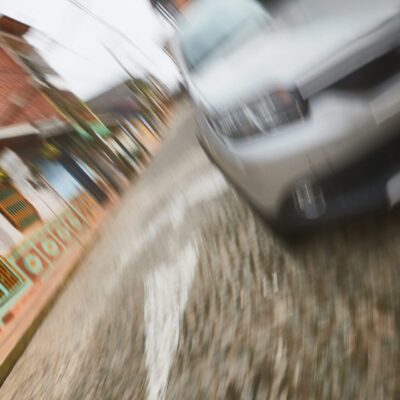 A blurry image of a car driving down a street.