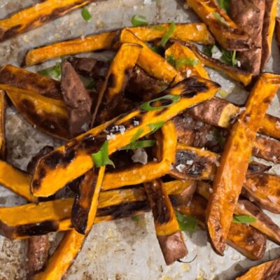 Grilled sweet potato fries on a baking sheet.