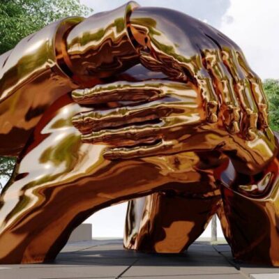 A bronze sculpture of a man holding a woman's hand.